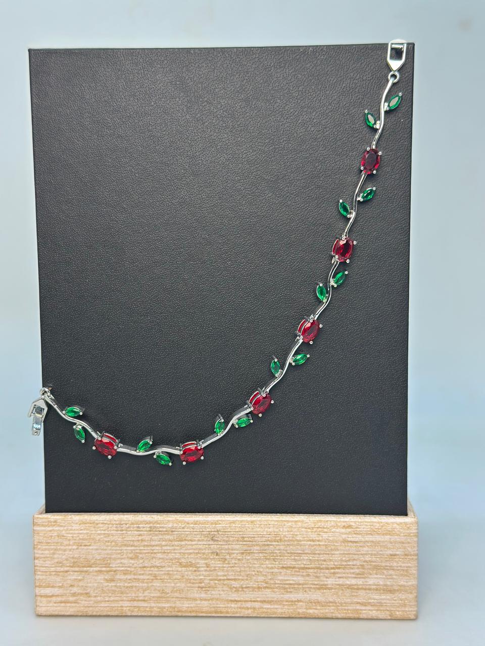 Elegant Stainless Steel Bracelet with Red and Green Gemstones